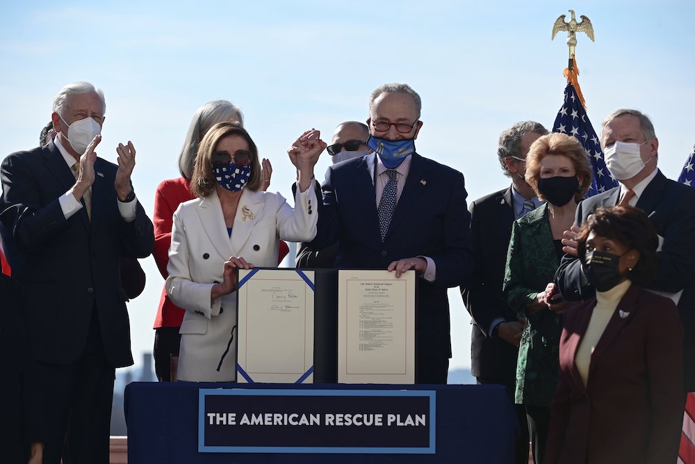 House Speaker Nancy Pelosi, D-Calif., and Senate Majority Leader Chuck Schumer, D-N.Y., display the "American Rescue Plan" March 10, 2021