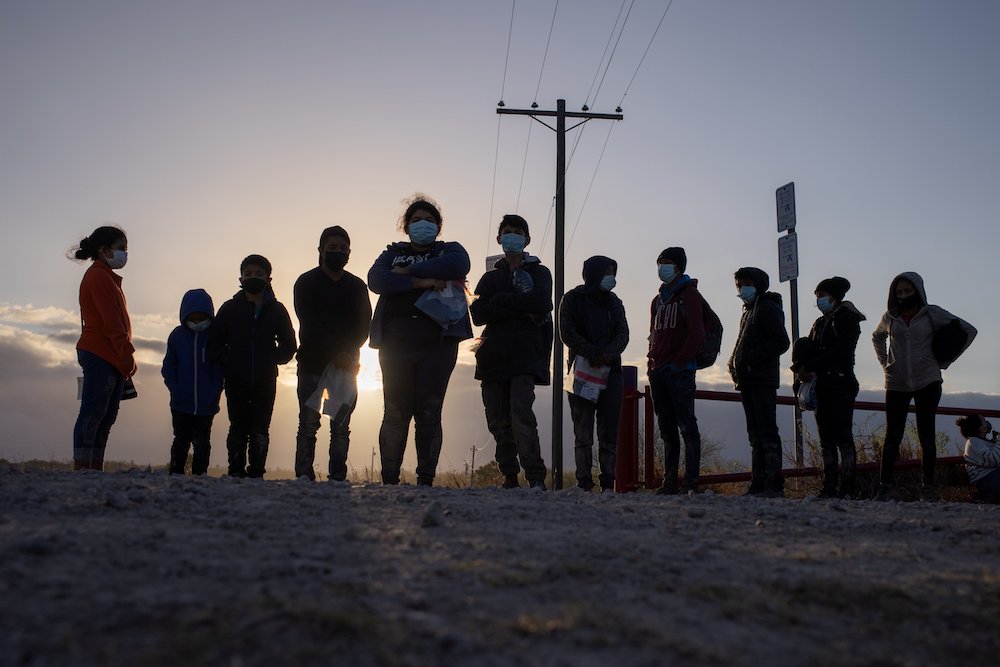 Unaccompanied minors seeking asylum in the U.S., await transport in Penitas, Texas, March 12, 2021, after crossing the Rio Grande