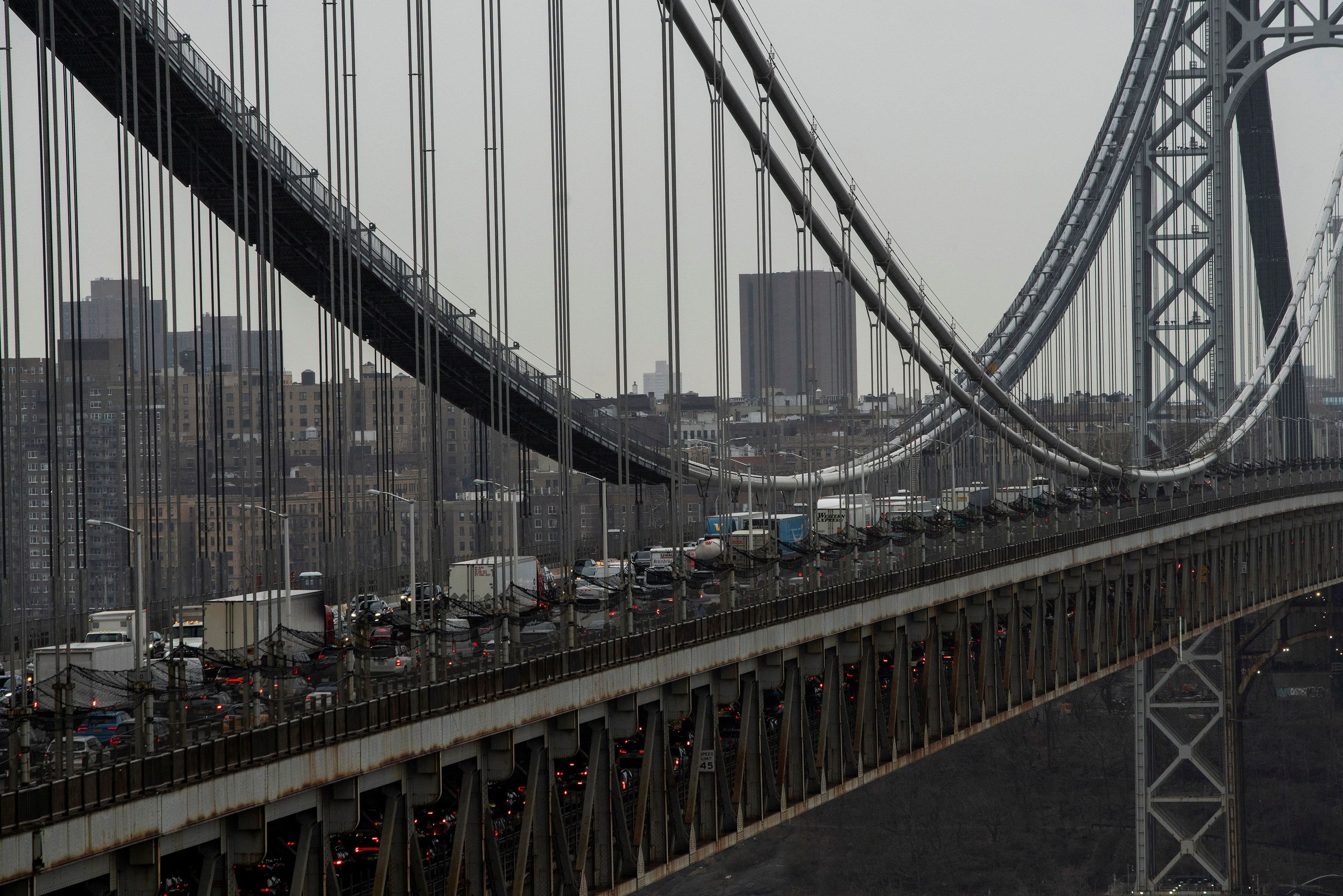 Large bridge viewed from above and side, full of cars