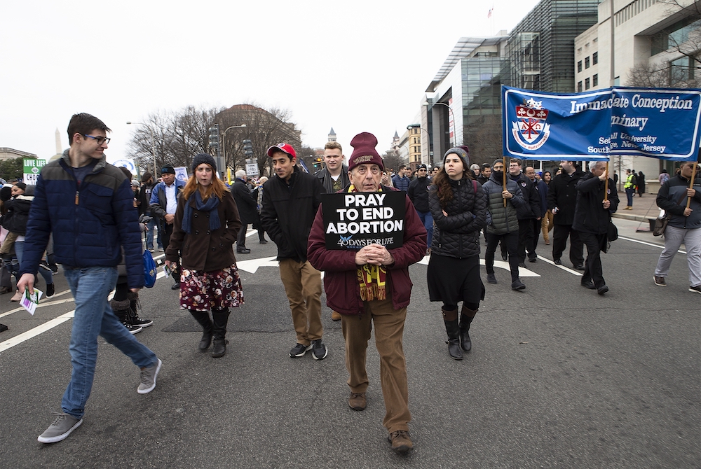 People walk up Constitution Avenue headed toward the U.S. Supreme Court while participating in the 47th annual March for Life in Washington Jan. 24. (CNS/Tyler Orsburn)