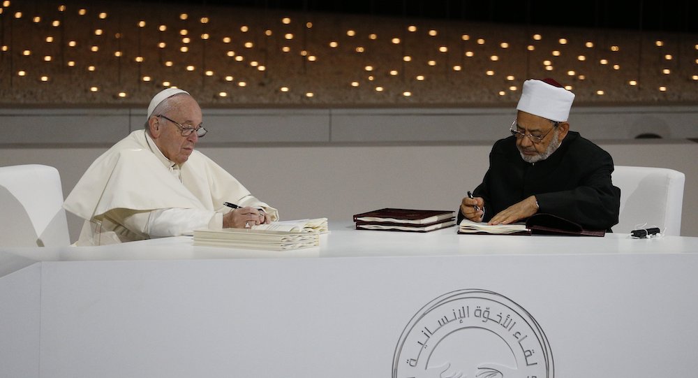 Pope Francis and Sheikh Ahmad el-Tayeb, grand imam of Egypt's al-Azhar mosque and university, sign documents during an interreligious meeting at the Founder's Memorial in Abu Dhabi, United Arab Emirates, Feb. 4, 2019. (CNS/Paul Haring)