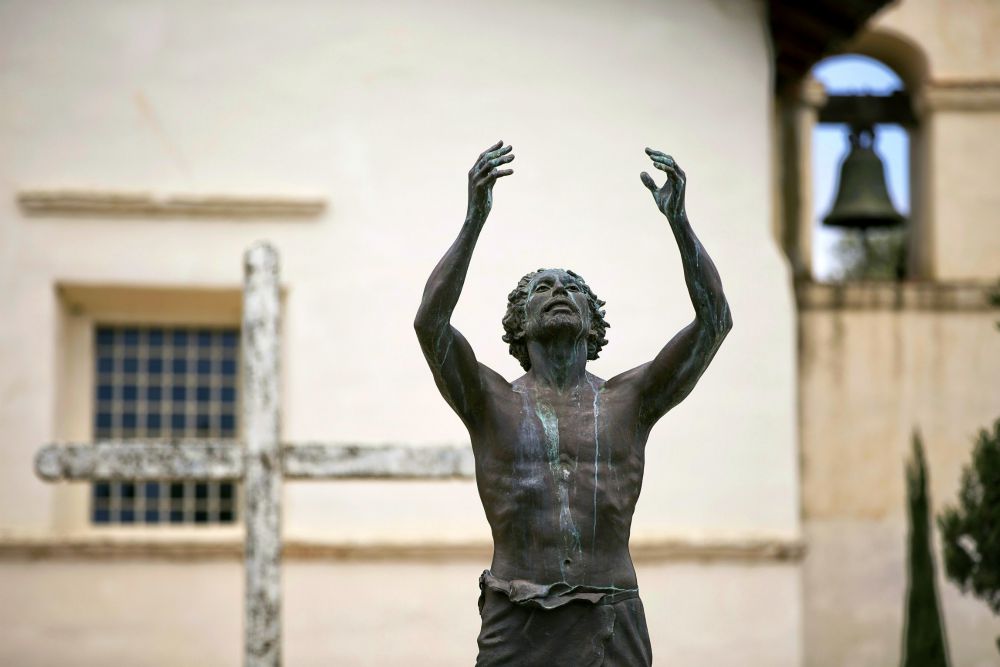 A statue of St. John the Baptist stands outside Old Mission San Juan Bautista in California. (CNS/Nancy Wiechec)