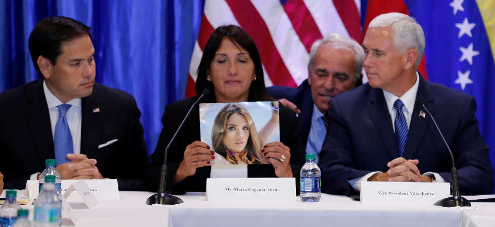 Sen. Marco Rubio, R-Florida, and Vice President Mike Pence listen to Maria Eugenia Tovar Aug. 23 at Our Lady of Guadalupe Church in Doral, Florida, as she holds a picture of her daughter who was killed in 2014 during a protest in Venezuela.