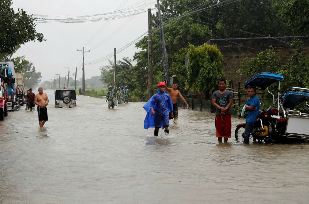 Residents walk through floodwaters in Nueva Ecija, Philippines, Sept 15, 2018, after Typhoon Mangkhut. (CNS/Reuters/Erik De Castro)