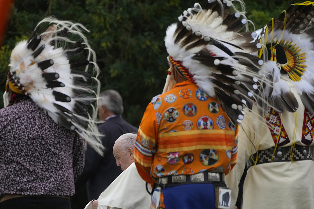 Pope Francis prays with Indigenous people in a cemetery at the former residential school in Maskwacis, near Edmonton, Canada, July 25. (AP/Gregorio Borgia)