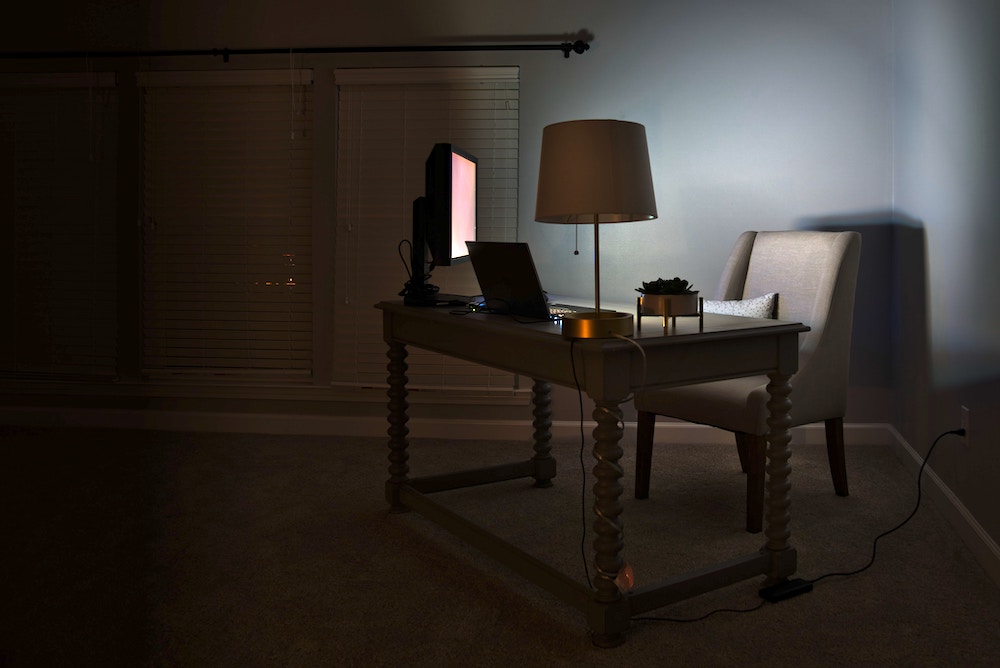 Photograph of a dimly lit room with desk and computer. Photograph of a dimly lit room with desk and computer.