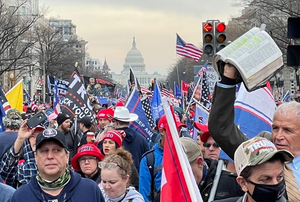 People march in Washington, D.C., in support of President Donald Trump, Dec. 12, waving flags and Bibles. The second such march following the election, it included a religious element, the Jericho March's "Let the Church Roar Prayer Rally" on the National