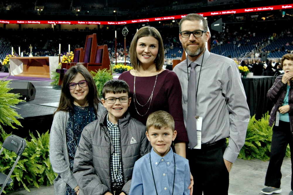 Katie and Toby Joyce pose with their children — Taylor, 12, Tanner, 10, and 7-year-old Brendan Solanus Joyce -- before the Nov. 18 Mass and beatification rite for Fr. Solanus Casey at Detroit's Ford Field. (William E. Odell)