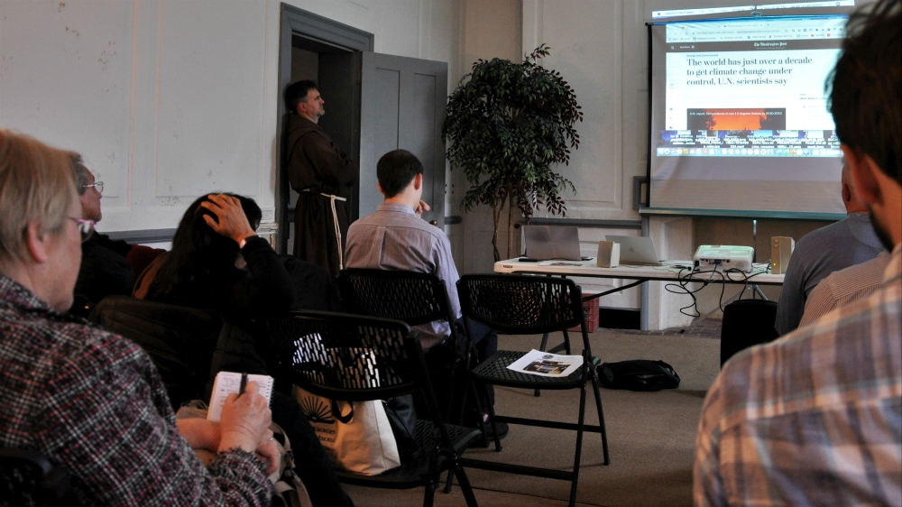 As part of their teach-in, Maryland Catholics watch a short video on the urgency of addressing climate change. (NCR photo/Jesse Remedios)