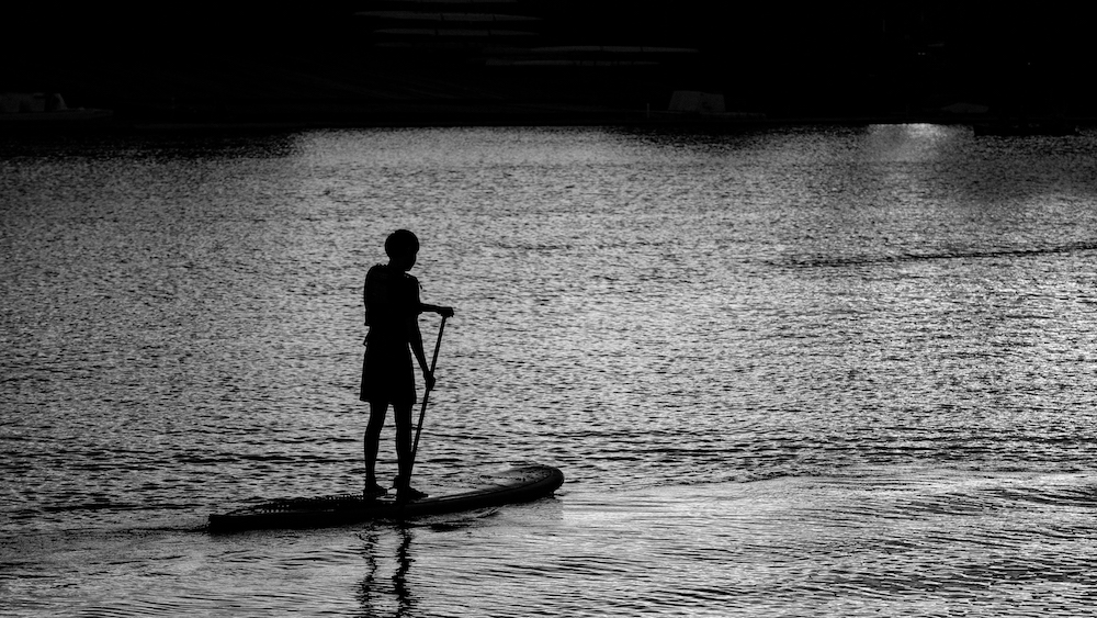 Person in silhouette on the water