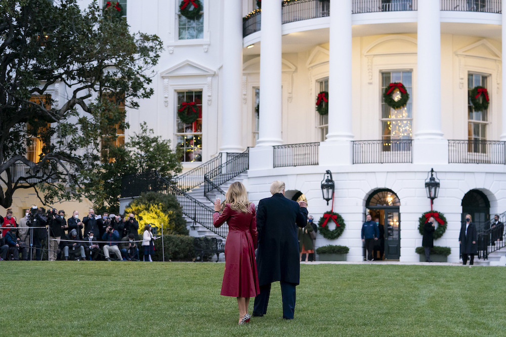 President Donald Trump and first lady Melania Trump wave to guests and members of the press as they walk across the South Lawn of the White House Dec. 5, before boarding Marine One to begin their trip to Georgia. (Flickr/White House/Tia Dufour)