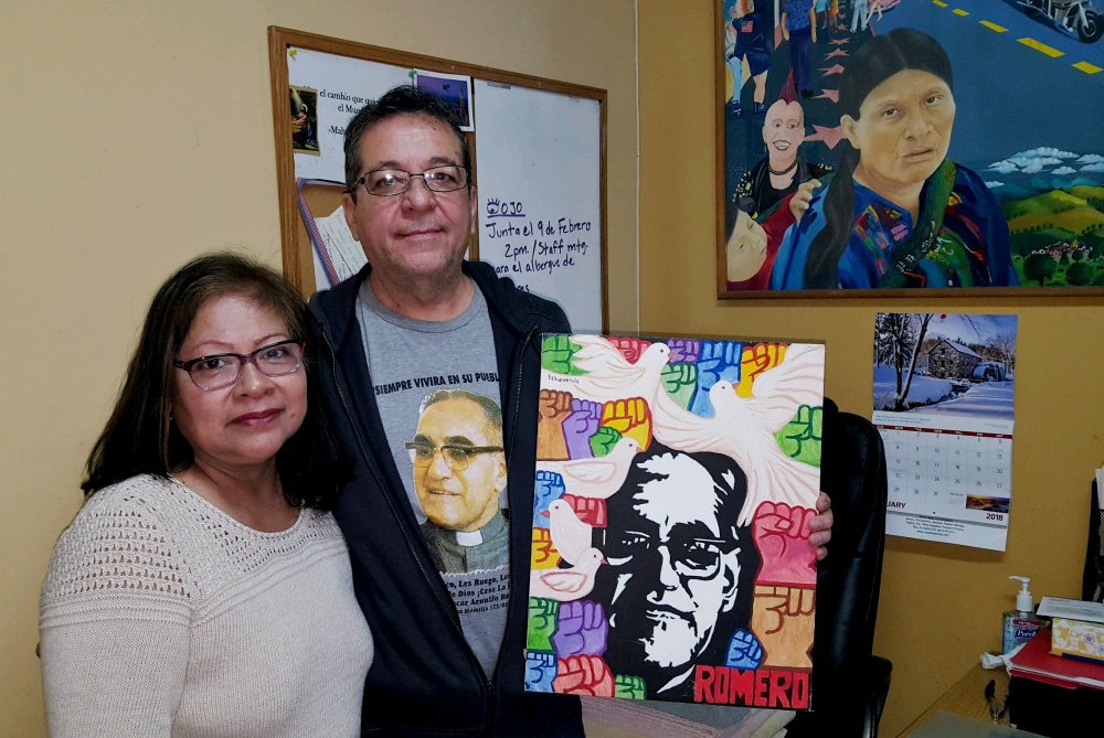 Many images of Blessed Archbishop Óscar Romero adorn the office of Tony Arteaga, shown here with his wife, Delmy, at Los Angeles’ Dolores Mission Parish. (NCR photo/Dan Morris-Young) Many images of Blessed Archbishop Óscar Romero adorn the office of Tony Arteaga, shown here with his wife, Delmy, at Los Angeles’ Dolores Mission Parish. (NCR photo/Dan Morris-Young)