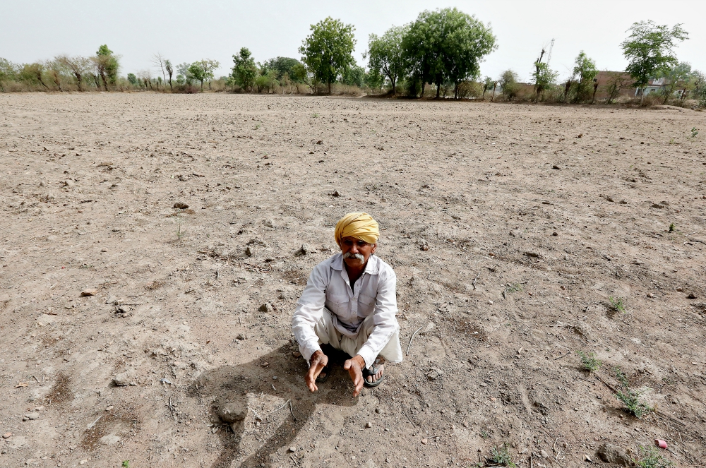 An Indian farmer sits on a dry field in May 2018 outside Chhatarpur. (CNS/EPA/Harish Tyagi) An Indian farmer sits on a dry field in May 2018 outside Chhatarpur. (CNS/EPA/Harish Tyagi)