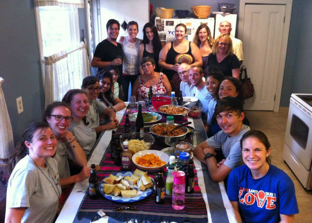 The Cleveland Jesuit Volunteer Corps family share a meal in this August 2015 photo. (Provided photo)