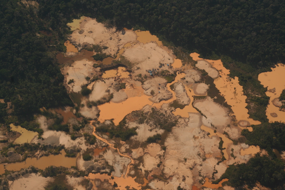 A new area of unregulated gold mining in Peru's Madre de Dios region leaves a barren, cratered scar in the forest. (Photo/Barbara Fraser)