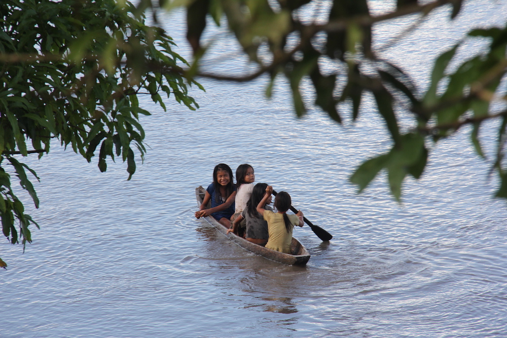 Shipibo children paddle a canoe near their village in Peru's Ucayali region. (Photo/Barbara Fraser)