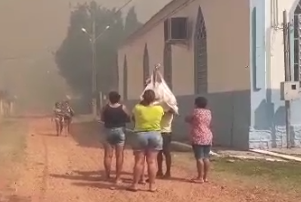 Edir Silva and neighbors save statue Community leader Edir Silva and others removed a 200-year-old statue of Our Lady of Mount Carmel out of their local chapel Sept. 7, as a wildfire threatened to engulf the village of Forte Coimbra. (Courtesy of Edir Silva)
