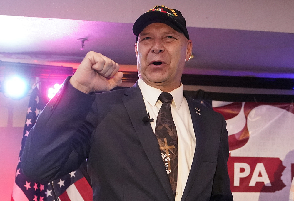 State Sen. Doug Mastriano, R-Franklin, the Republican candidate for governor of Pennsylvania, gestures to the cheering crowd during his primary night election party May 17 in Chambersburg, Pennsylvania. (AP photo/Carolyn Kaster)