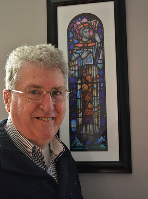 Fr. Seán McDonagh, eco-theologian and a Columban missionary, is pictured in front of an image of St. Columban. (Sarah Mac Donald)