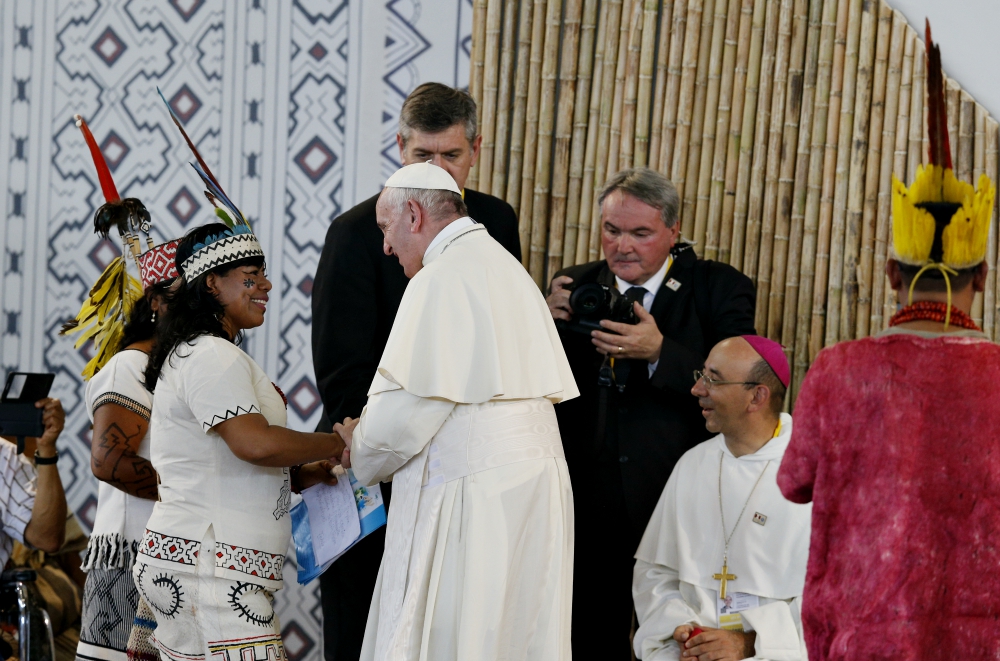 Pope Francis greets members of an indigenous group from the Amazon region during a Jan. 19, 2018, meeting at Madre de Dios stadium in Puerto Maldonado, Peru. (CNS/Paul Haring)