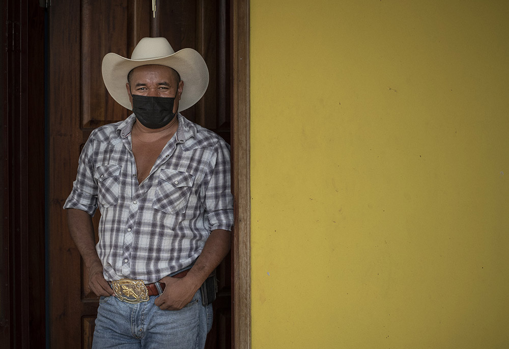 Freddy Murio at the doorway to his home in Yorito, Honduras. After 12 years as an undocumented immigrant in New York, Murio is now running for mayor of his hometown, hoping to address the ills driving an exodus from the country. (Manuel Ortiz Escámez)