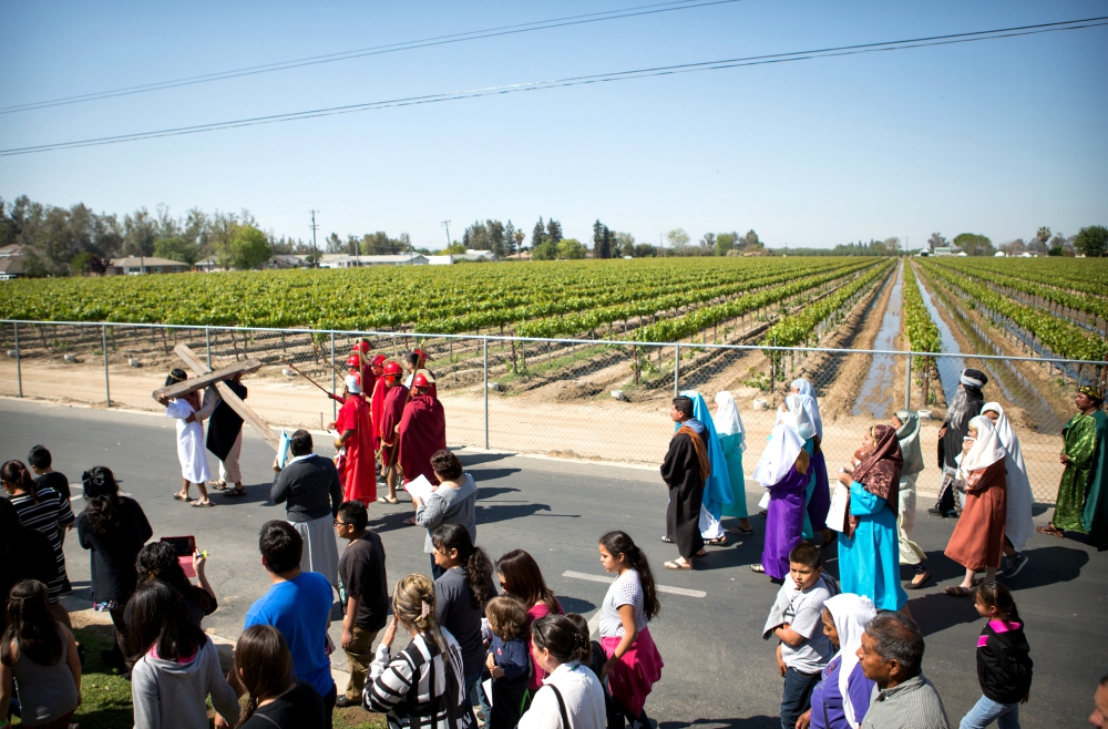 A person carrying a cross leads the Way of the Cross procession on Good Friday in the Diocese of Fresno, California, April 3, 2015. The tradition of a living Stations of the Cross is especially strong in the diocese's migrant communities. (CNS) A person carrying a cross leads the Way of the Cross procession on Good Friday in the Diocese of Fresno, California, April 3, 2015. The tradition of a living Stations of the Cross is especially strong in the diocese's migrant communities. (CNS)