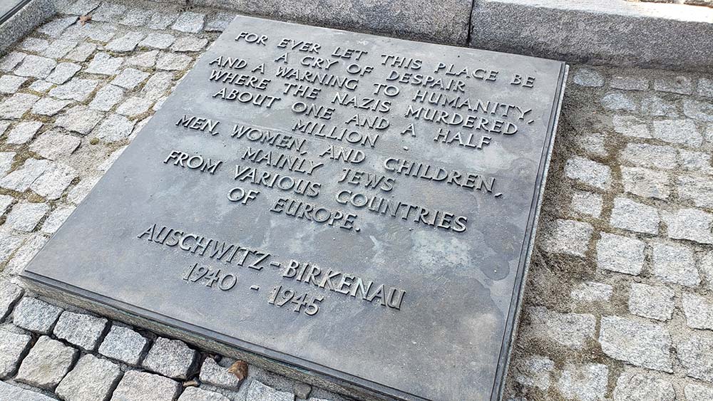 A marker near the destroyed crematoria within the Birkenau section of the Auschwitz-Birkenau concentration-death camp commemorates the more than 1 million people who were killed at the facility. (NCR photo/Chris Herlinger)