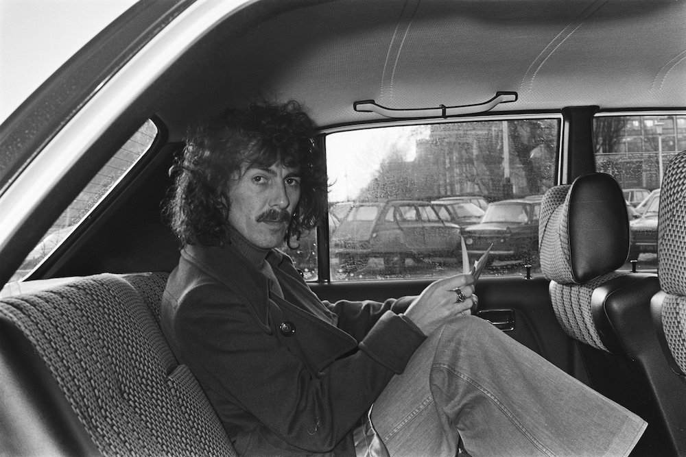 George Harrison is pictured in the back seat of a car as he leaves the Hilton hotel in Amsterdam, the Netherlands, Feb 4, 1977. (National Archives, Anefo collection/Suyk, Koen)