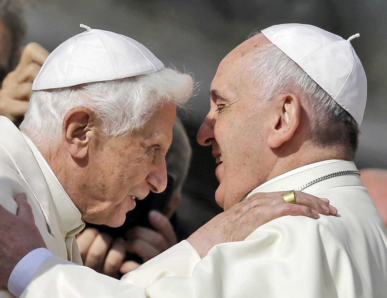 Pope Francis, right, hugs Pope Emeritus Benedict XVI prior to the start of a meeting with elderly faithful in St. Peter's Square at the Vatican, Sunday, Sept. 28, 2014. (AP Photo/Gregorio Borgia, File)