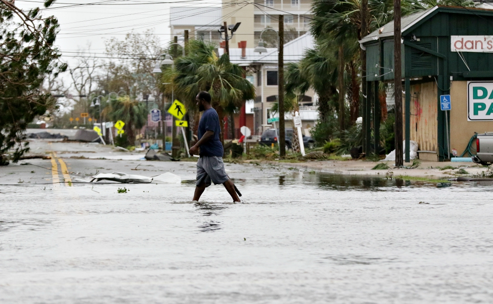 A man walks through a flooded street Oct. 10, 2018, after Hurricane Michael swept through Panama City Beach, Florida. (CNS/EPA/Michael Anderson)