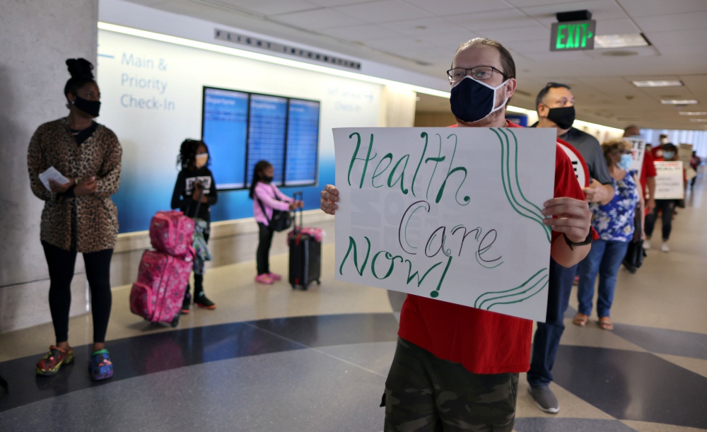 A person holds a sign as laid off LAX Airport workers protest for an extension of health care benefits by concessions companies in Los Angeles Sept. 24. (CNS/Reuters/Lucy Nicholson) A person holds a sign as laid off LAX Airport workers protest for an extension of health care benefits by concessions companies in Los Angeles Sept. 24. (CNS/Reuters/Lucy Nicholson)