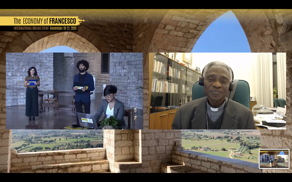 Cardinal Peter Turkson, prefect of the Dicastery for the Promotion of Integral Human Development, right, addresses participants of the Economy of Francesco conference, on its first day Nov. 19. (NCR screenshot)