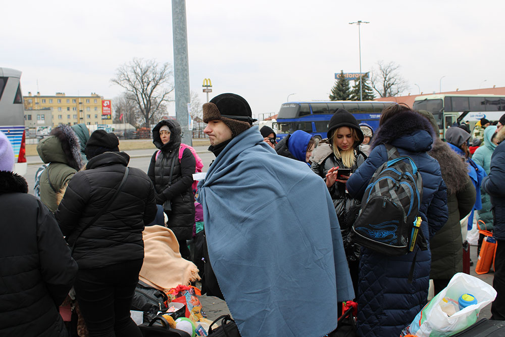 Recent arrivals from Ukraine at a refugee reception center in Przemyśl, Poland, await buses to take them to other locales in Poland or elsewhere in Europe. (NCR photo/Chris Herlinger)