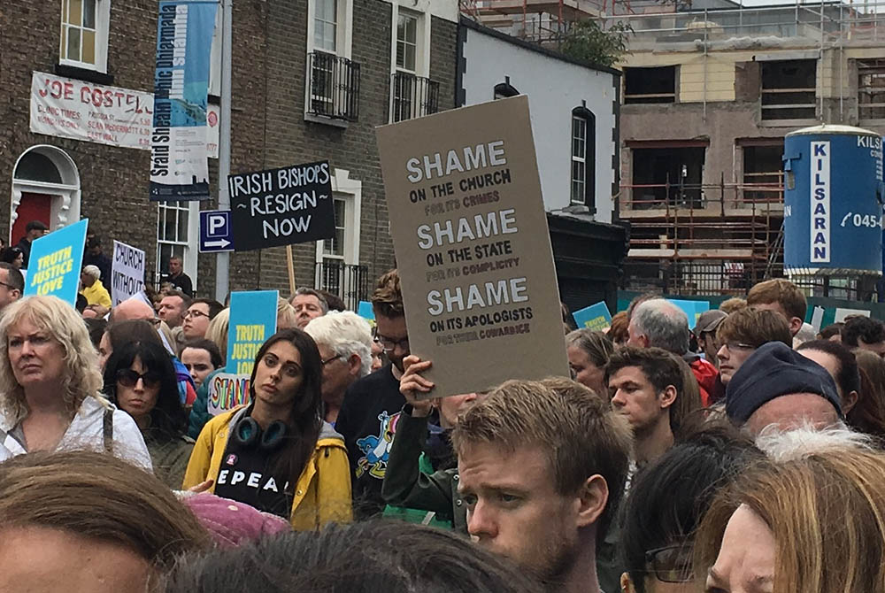 Demonstrators in a Stand4Truth rally for victims of abuse in the Catholic Church processed to a former Magdalene laundry in Dublin on Aug. 26, 2018, holding signs demanding justice from the church and the Irish state. (NCR photo/Jamie Manson)