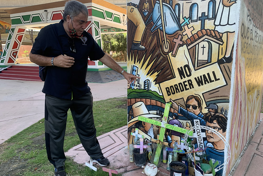 Enrique Morones, pictured Aug. 27 in Chicano Park, in San Diego, California, points to a mural done for immigration. Morones appears in the mural. (Melissa Cedillo)