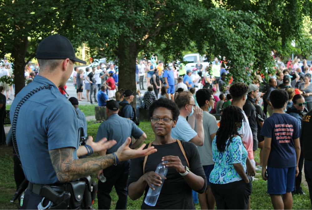 Justine Kenner speaks with a police officer ahead of a "Unity March" in Kansas City, Missouri, June 3. (NCR photo/Brian Roewe)