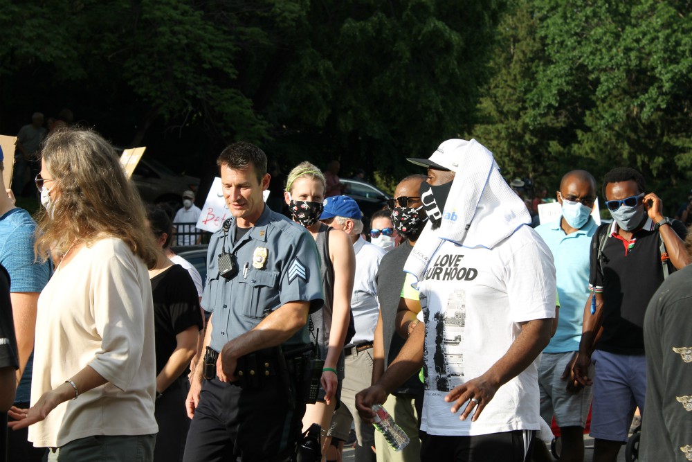 A Kansas City, Missouri, police officer walks with protesters during a "Unity March" June 3 in response to the death of George Floyd in Minneapolis. (NCR photo/Brian Roewe)