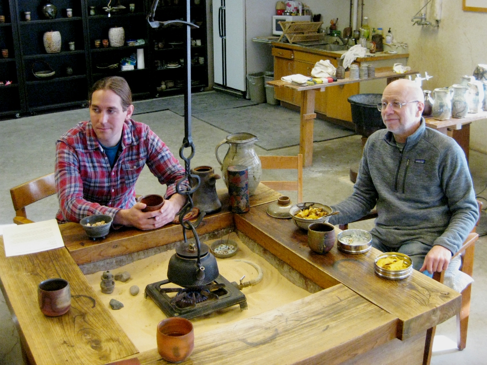 Artist in residence and director Richard Bresnahan, right, and studio manager Ryan Kutter chat at the table where tea is served at St. John's Pottery. (Zoe Ryan)