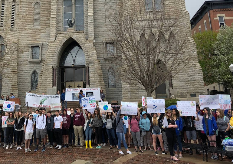 Hundreds of Creighton University students demonstrate outside St. John's Church on the Omaha, Nebraska campus in April pressing the Jesuit school to take increased action on climate change, including divesting its endowment from fossil fuels. (Emily Burke