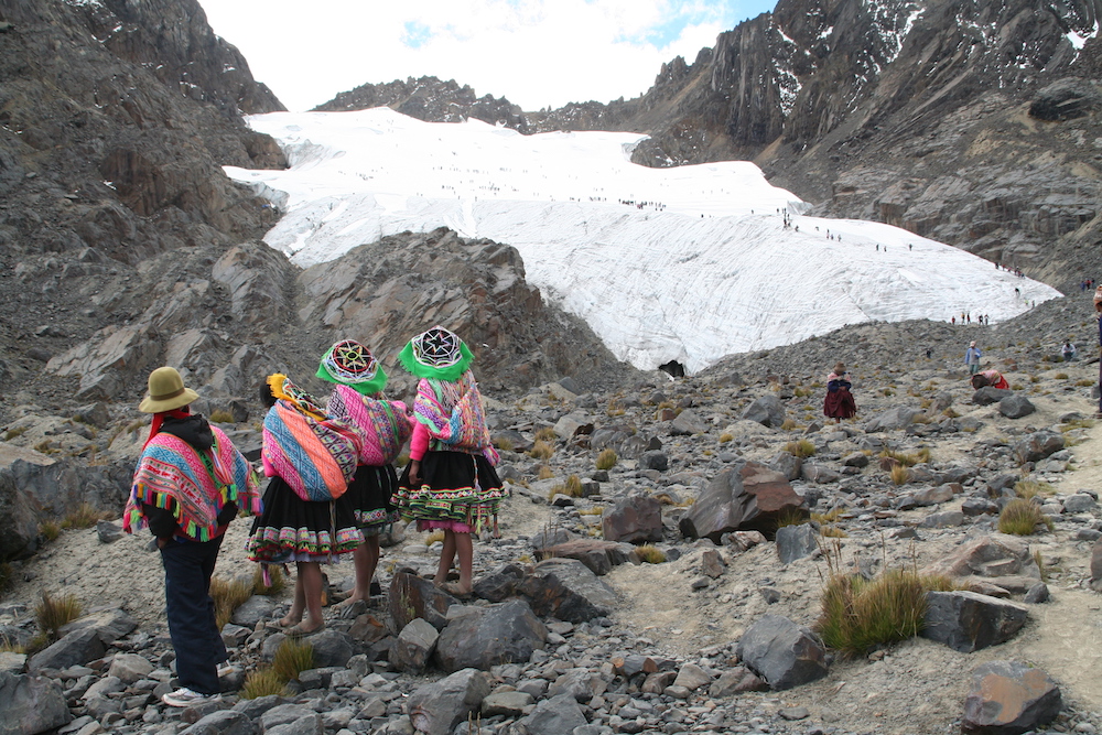 Participants in the annual Qoyllur Rit'i pilgrimage in Peru in 2009 look at a glacier at the pilgrimage destination high in the Andes Mountains. Decades earlier, the glacier extended to the place where they are standing, but a warming climate is shrinking