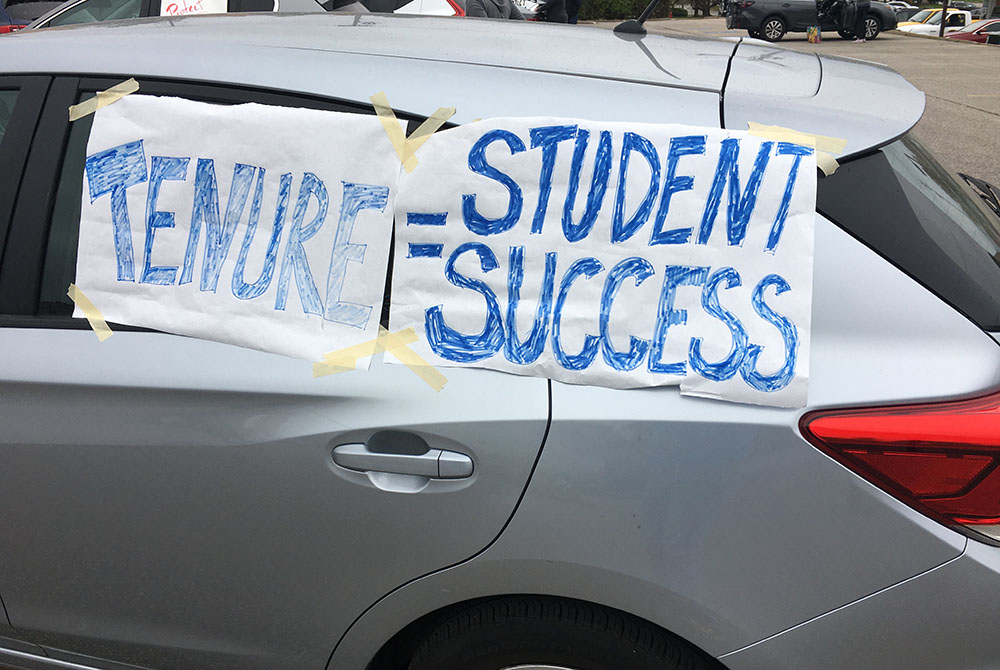 Signs adorn a car in an Oct. 18 alumni caravan protest against changes to the faculty handbook at John Carroll University in the Cleveland suburbs. (Courtesy of Kevin Henderson)
