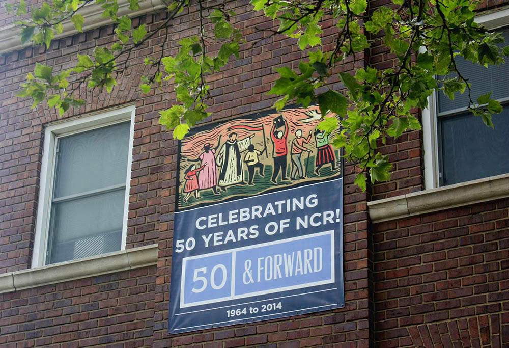 A banner celebrating the National Catholic Reporter's 50th anniversary is seen on the company's headquarters in Kansas City, Missouri. (NCR photo/Teresa Malcolm)