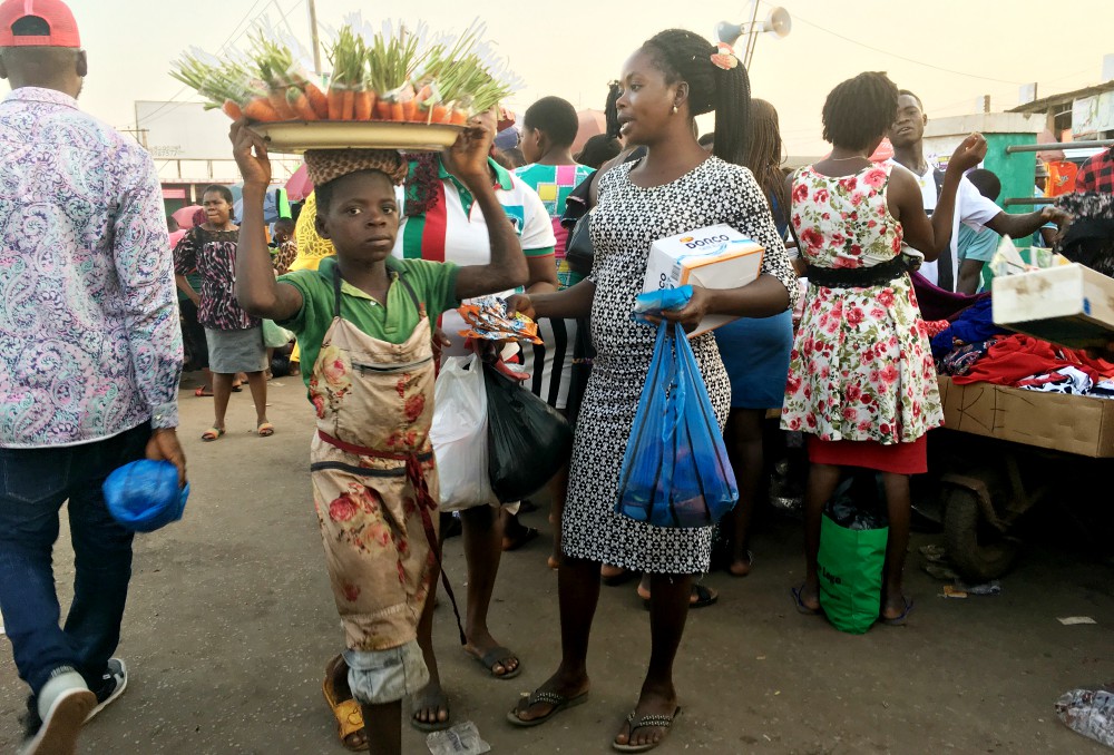 A child hawks carrots at a market in Enugu State, Nigeria. (Patrick Egwu) A child hawks carrots at a market in Enugu State, Nigeria. (Patrick Egwu)