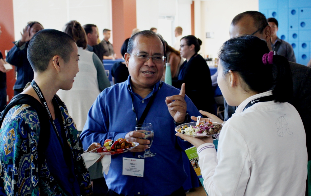 Robert Yabes, program director for Catholic Charities of Santa Clara County's Immigrant and Legal Services, talks with other with San Francisco Bay Area GSBI Boost attendees July 26. (Heather Adams)
