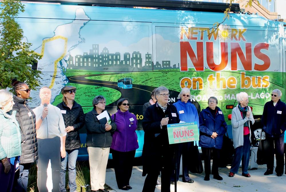 Mercy Sr. Kathy Thornton speaks at a Nuns on the Bus rally in Greene Square in Cedar Rapids, Iowa, Oct. 17. Second from left is a cardboard cutout of Republican Rep. Rod Blum. (NCR photo/Brian Roewe)