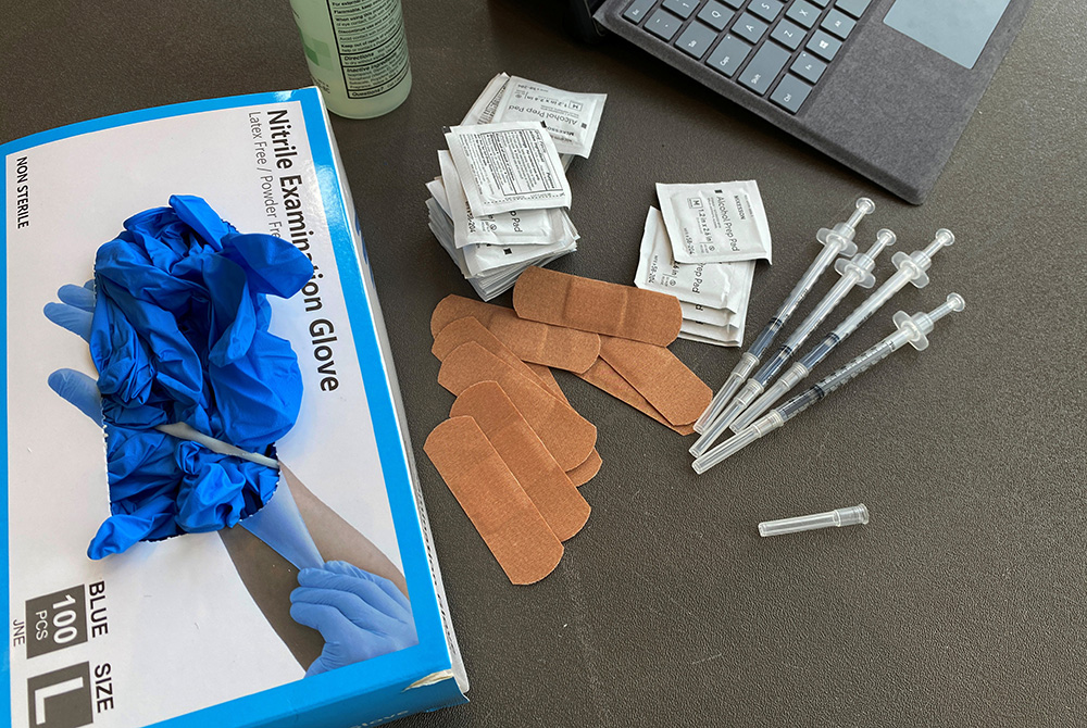IN-DEPTH-COLLEGE-VACCINES Syringes and gloves are pictured on the campus of the University of Memphis in Tennessee July 22, as students receive COVID-19 vaccines. Boston College requires all students and faculty be vaccinated for COVID-19. (CNS/Reuters/Karen Pulfer Focht)