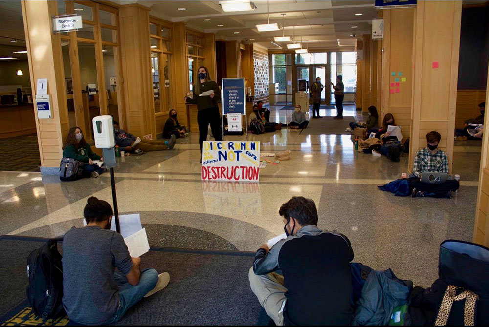 Students protest budget cuts during an Oct. 21 sit-in at Marquette’s main academic building. (Courtesy of Brooke McArdle)