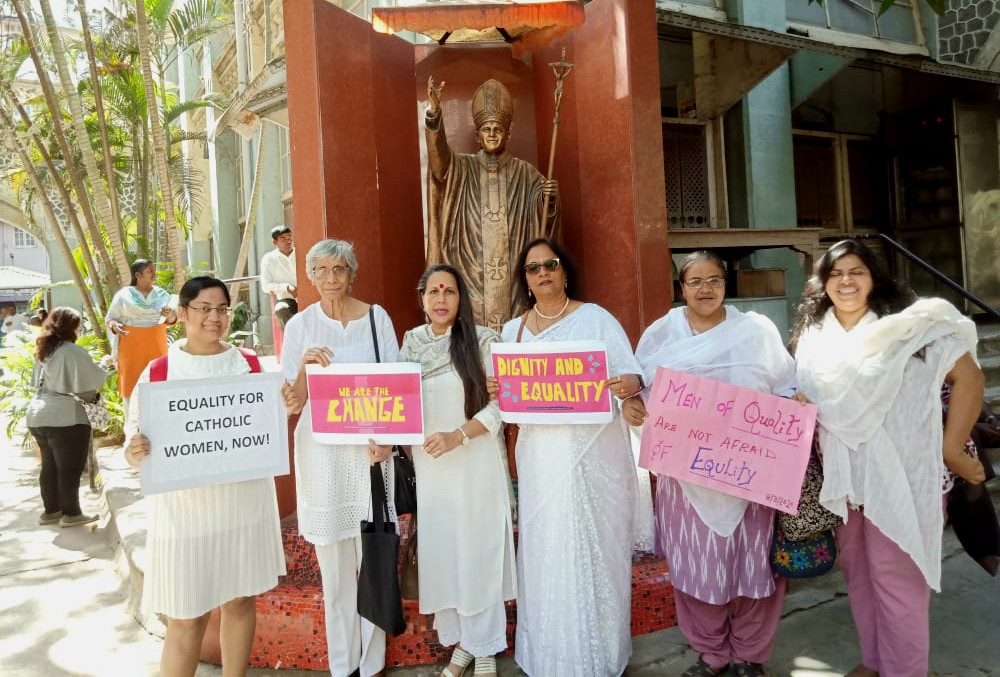 Several of the signatories of the petition to Cardinal Oswald Gracias of Mumbai, India, stand together in front of a statue of Pope John Paul II near Mumbai's Holy Name Cathedral March 8. (Courtesy of Astrid Lobo Gajiwala)