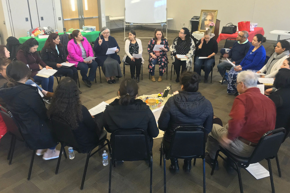 Students of Escuela de Capacitación Pastoral, the diocese of Joliet's existing Latino Leadership Formation Program, participate in a group activity, before the pandemic. (Provided photo)