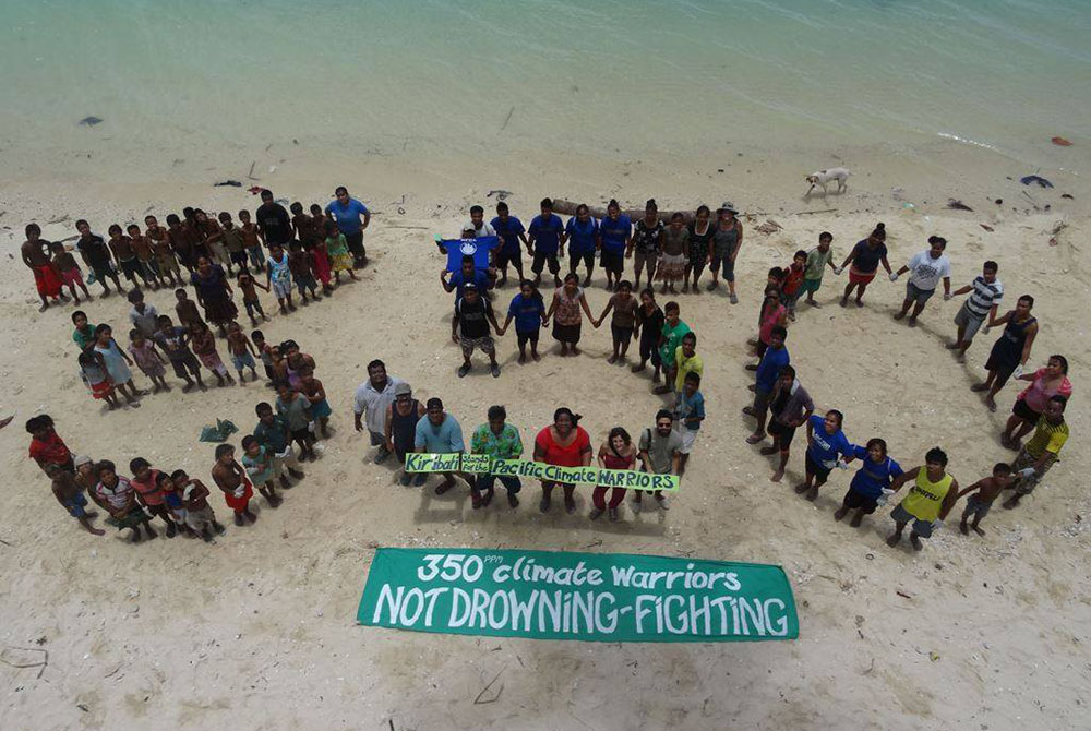 Members of the Pacific Climate Warriors on the island of Kiribati form the number 350, a number representing the safe maximum level of carbon dioxide in the atmosphere. (Courtesy of Pacific Climate Warriors)